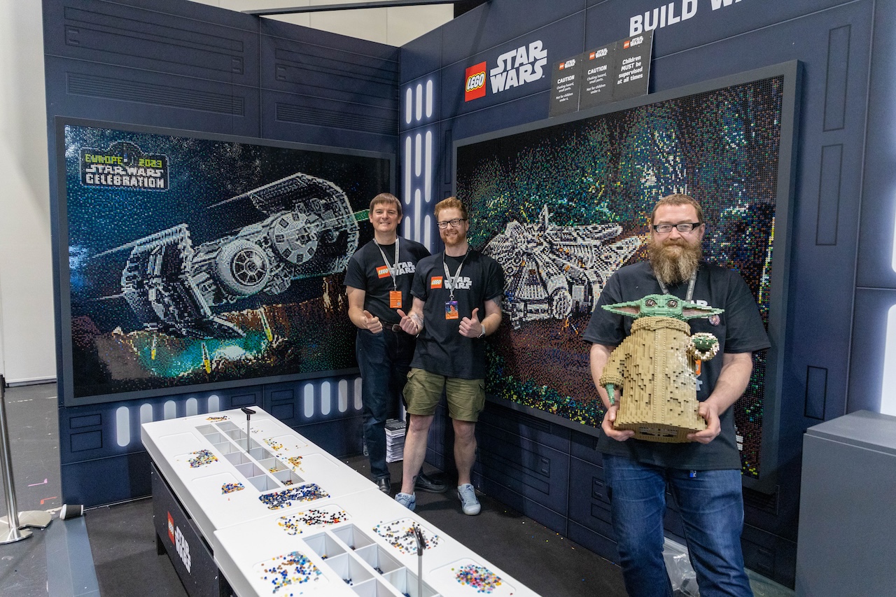A group of men holding lego